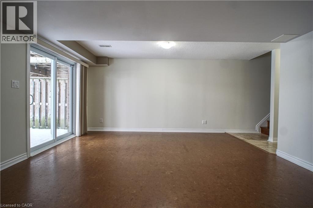 Unfurnished room featuring stairs and finished concrete flooring - 919 Zeller Crescent, Kitchener, ON - Indoor Photo Showing Other Room