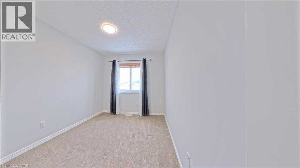 Unfurnished room with a textured ceiling and light colored carpet - 919 Zeller Crescent, Kitchener, ON - Indoor Photo Showing Other Room