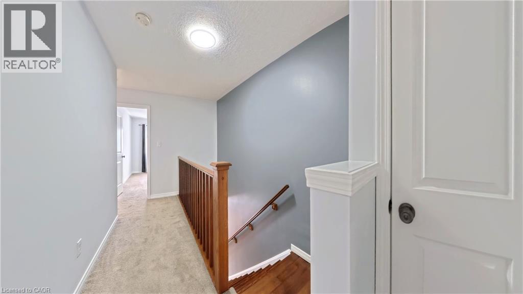 Hall with an upstairs landing, a textured ceiling, and carpet - 919 Zeller Crescent, Kitchener, ON - Indoor Photo Showing Other Room