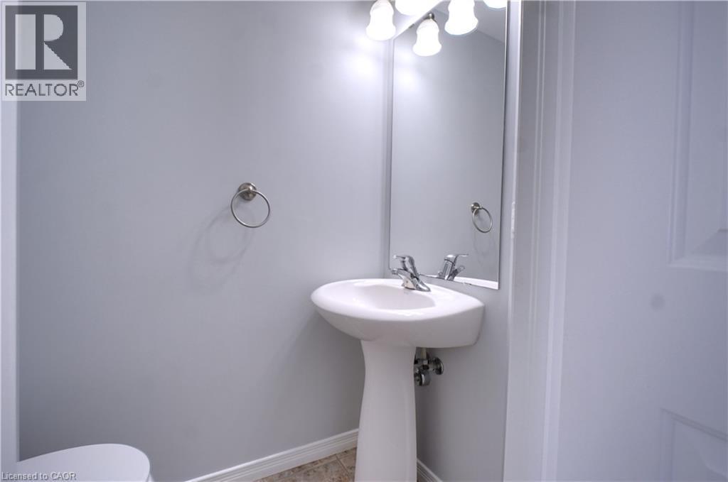 Half bath with baseboards and toilet - 919 Zeller Crescent, Kitchener, ON - Indoor Photo Showing Bathroom