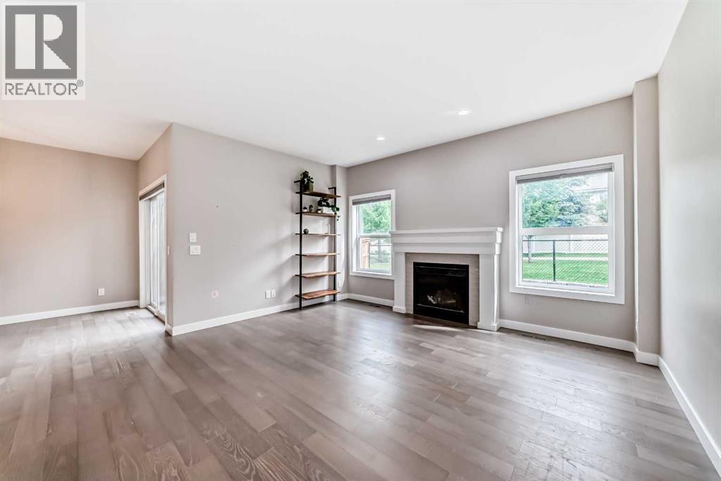 41 Shawnee Green Sw, Calgary, AB - Indoor Photo Showing Living Room With Fireplace