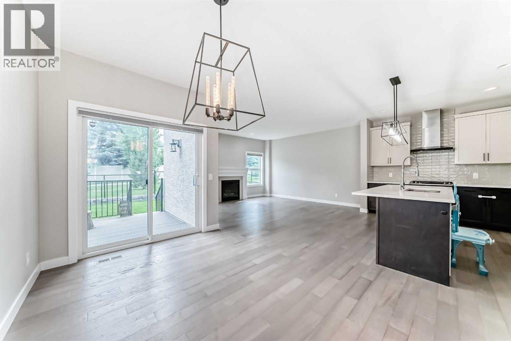 41 Shawnee Green Sw, Calgary, AB - Indoor Photo Showing Kitchen With Fireplace