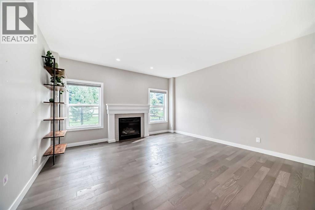 41 Shawnee Green Sw, Calgary, AB - Indoor Photo Showing Living Room With Fireplace