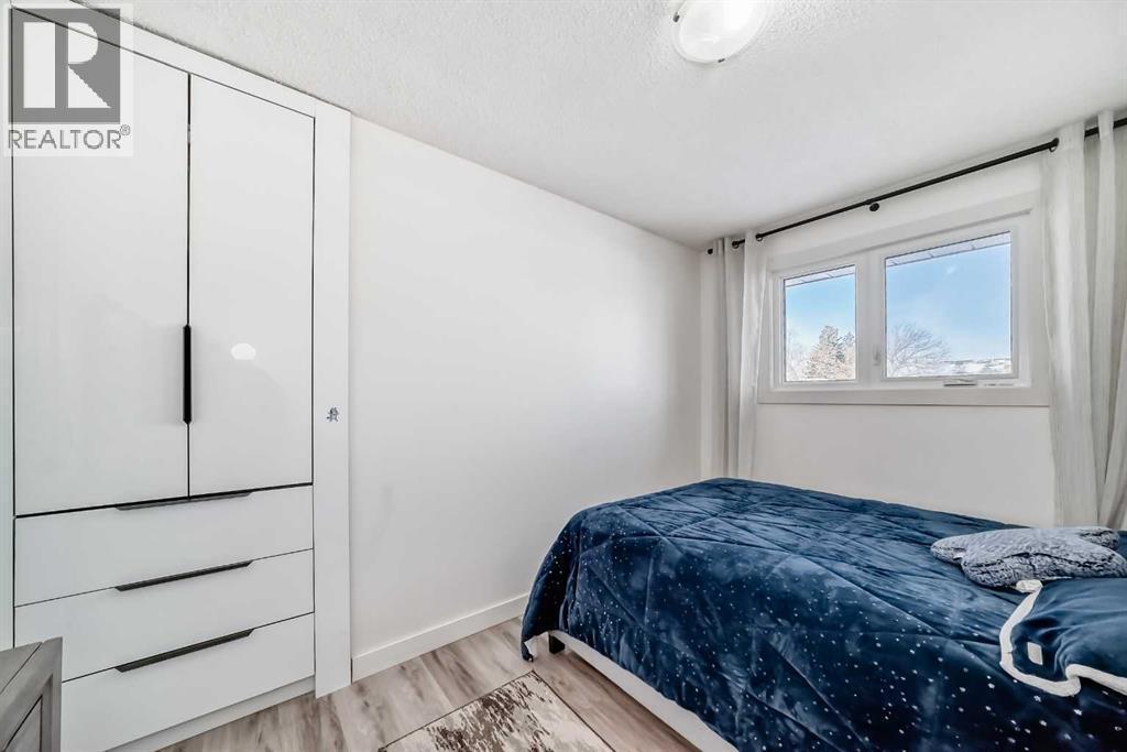 Bedroom 2 overlooks backyard - 216 Pinecrest Crescent Ne, Calgary, AB - Indoor Photo Showing Bedroom