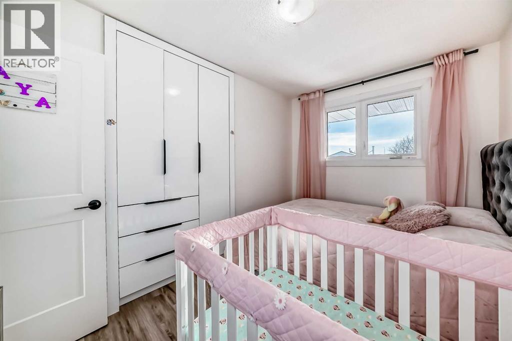Bedroom 3 with built in closet - 216 Pinecrest Crescent Ne, Calgary, AB - Indoor Photo Showing Bedroom