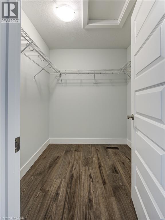 Walk in closet featuring dark wood-type flooring - 2527 Holbrook Drive, London, ON - Indoor With Storage