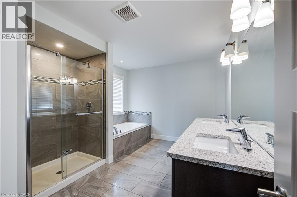 Bathroom with a shower stall, a garden tub, and double vanity - 2527 Holbrook Drive, London, ON - Indoor Photo Showing Bathroom