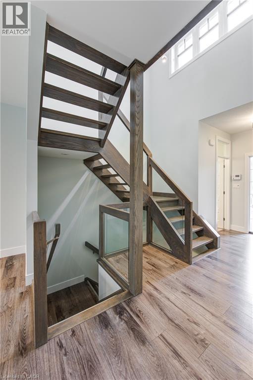 Staircase with wood finished floors, plenty of natural light, and a high ceiling - 2527 Holbrook Drive, London, ON - Indoor Photo Showing Other Room
