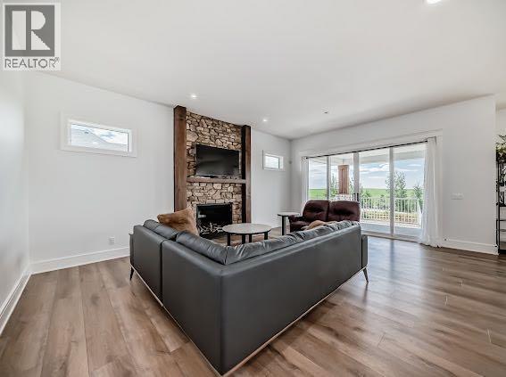 60 Junegrass Terrace, Rural Rocky View County, AB - Indoor Photo Showing Living Room With Fireplace