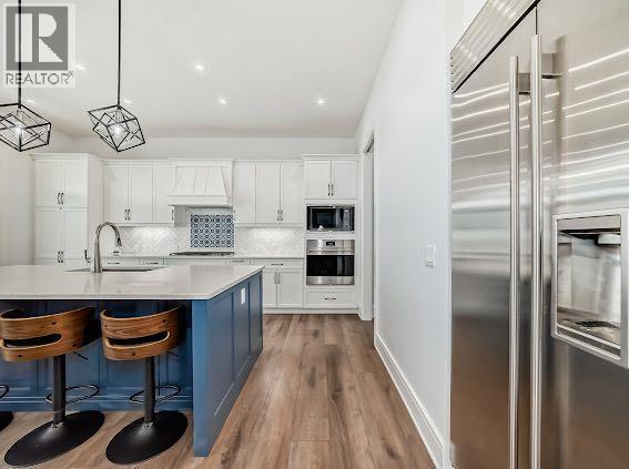 60 Junegrass Terrace, Rural Rocky View County, AB - Indoor Photo Showing Kitchen With Upgraded Kitchen