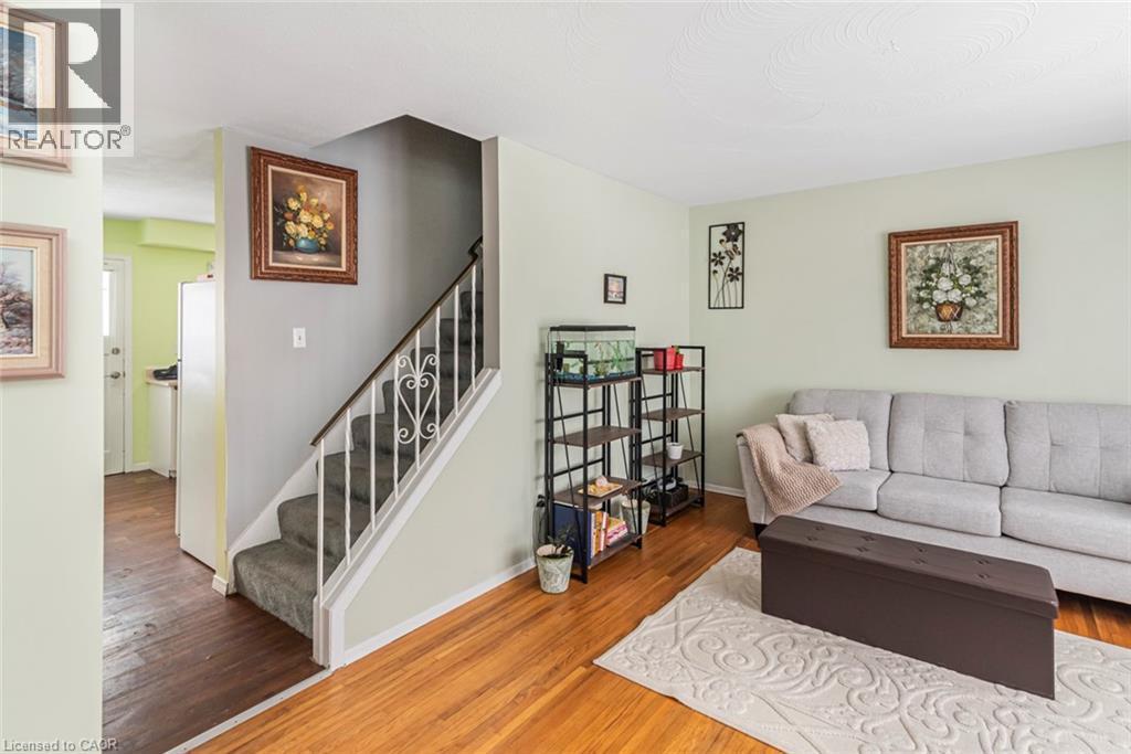 Living room with wood finished floors and stairway - 48 Riverdale Drive Unit# 2, Hamilton, ON - Indoor Photo Showing Living Room