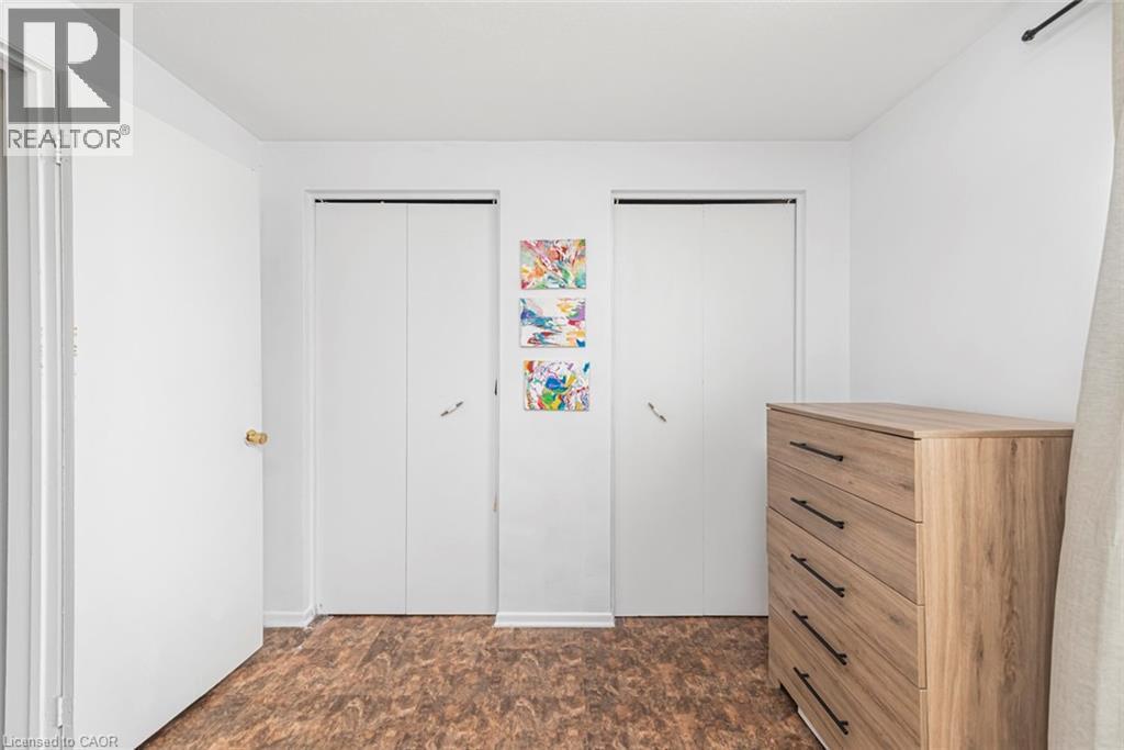 Bedroom with two closets and stone finish floors - 48 Riverdale Drive Unit# 2, Hamilton, ON - Indoor Photo Showing Other Room