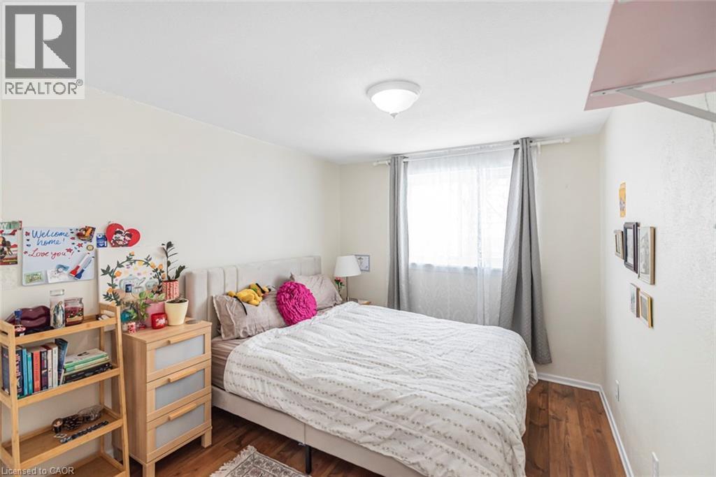 Bedroom with dark wood-style flooring and baseboards - 48 Riverdale Drive Unit# 2, Hamilton, ON - Indoor Photo Showing Bedroom