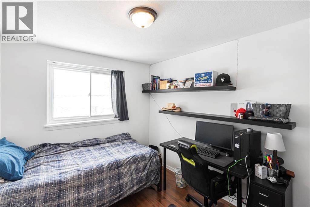 Bedroom featuring an office area and dark wood-style flooring - 48 Riverdale Drive Unit# 2, Hamilton, ON - Indoor Photo Showing Bedroom