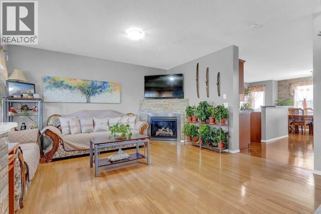 241 Covemeadow Road Ne, Calgary, AB - Indoor Photo Showing Living Room With Fireplace