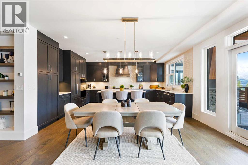 Dining into Ktichen - 102, 101A Stewart Creek Rise, Canmore, AB - Indoor Photo Showing Dining Room