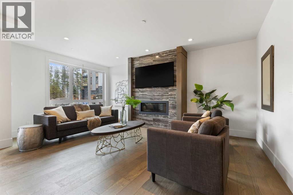 Living Room - 102, 101A Stewart Creek Rise, Canmore, AB - Indoor Photo Showing Living Room With Fireplace