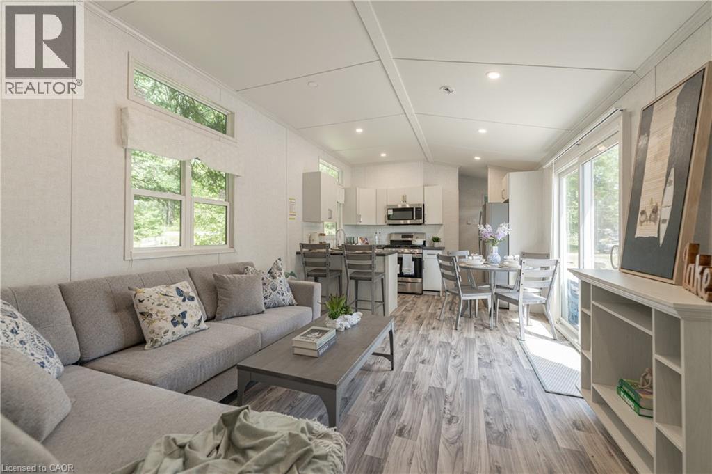 Living room with light wood-type flooring and recessed lighting - 85 Hutchinson Beach Road Unit# B56, Huntsville, ON - Indoor Photo Showing Living Room