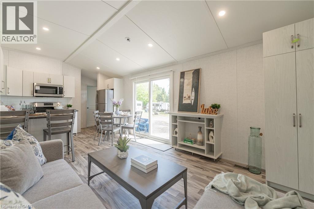 Living room featuring lofted ceiling, light wood-style floors, and recessed lighting - 85 Hutchinson Beach Road Unit# B56, Huntsville, ON - Indoor Photo Showing Living Room