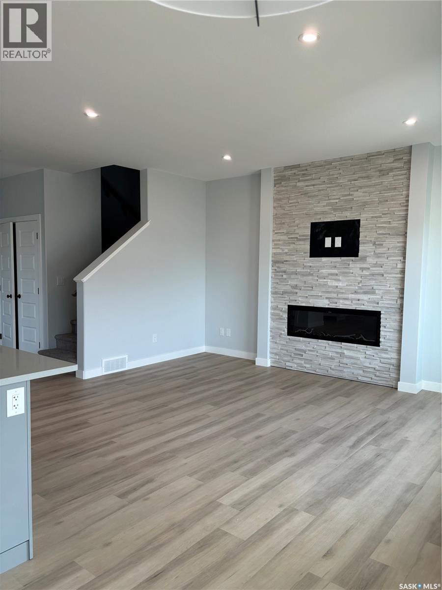 102 Kostiuk Crescent, Saskatoon, SK - Indoor Photo Showing Living Room With Fireplace
