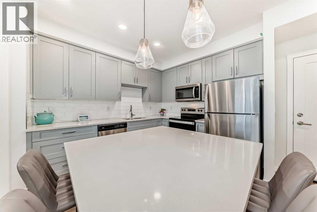 316, 200 Shawnee Square Sw, Calgary, AB - Indoor Photo Showing Kitchen With Stainless Steel Kitchen With Upgraded Kitchen
