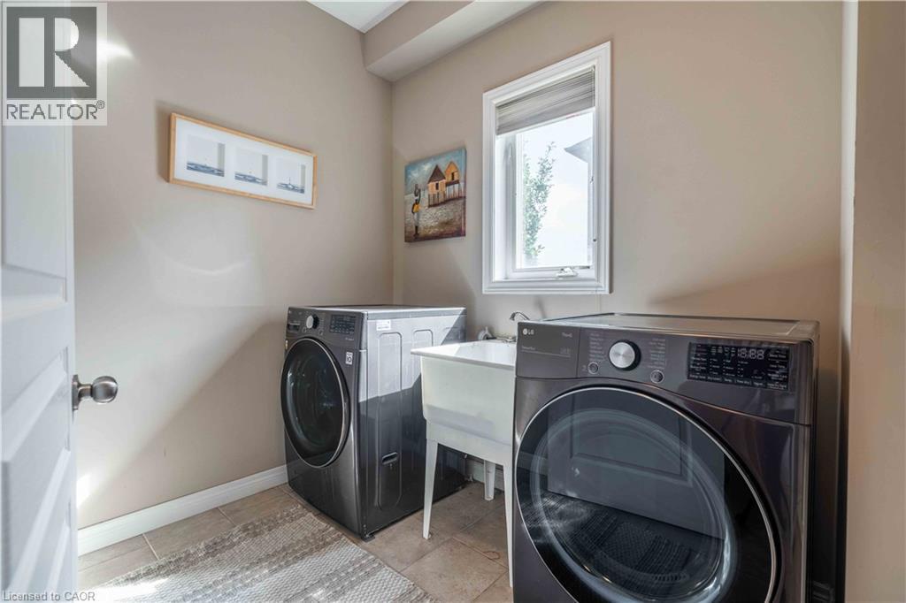 Main level laundry serves as mudroom with direct access to garage. - 51 Showcase Drive, Hamilton, ON - Indoor Photo Showing Laundry Room