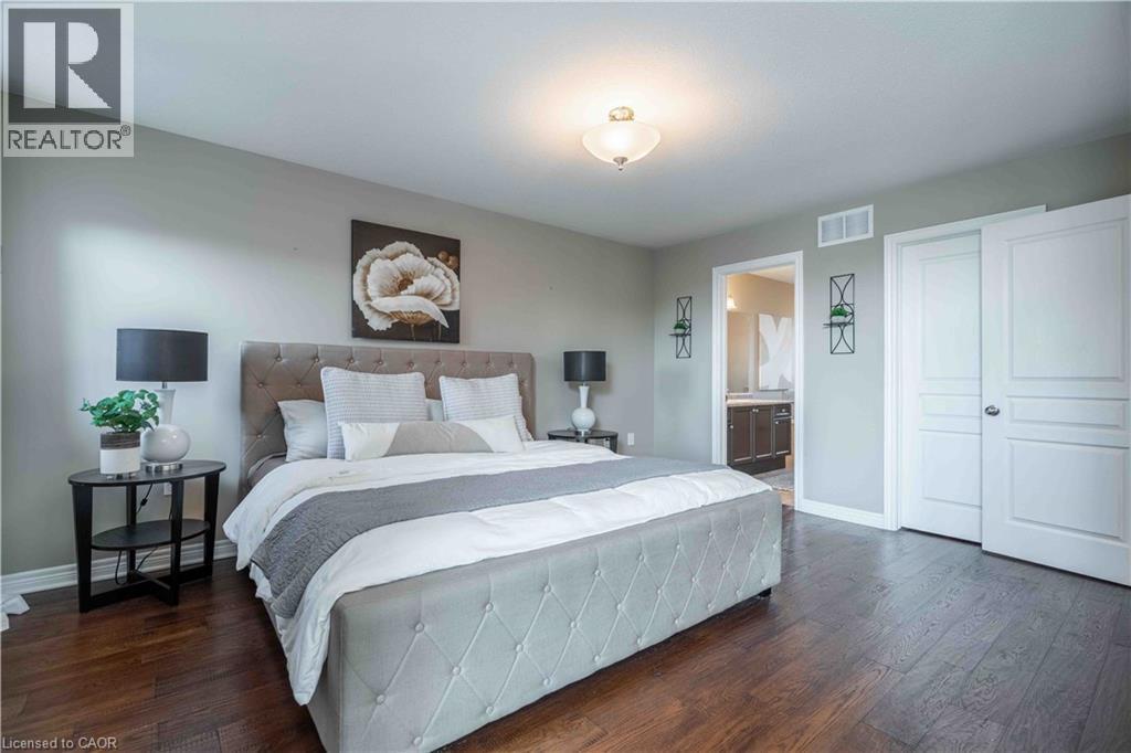 Elegant Primary Bedroom with double door entry, ensuite bath and walk-in closet - 51 Showcase Drive, Hamilton, ON - Indoor Photo Showing Bedroom