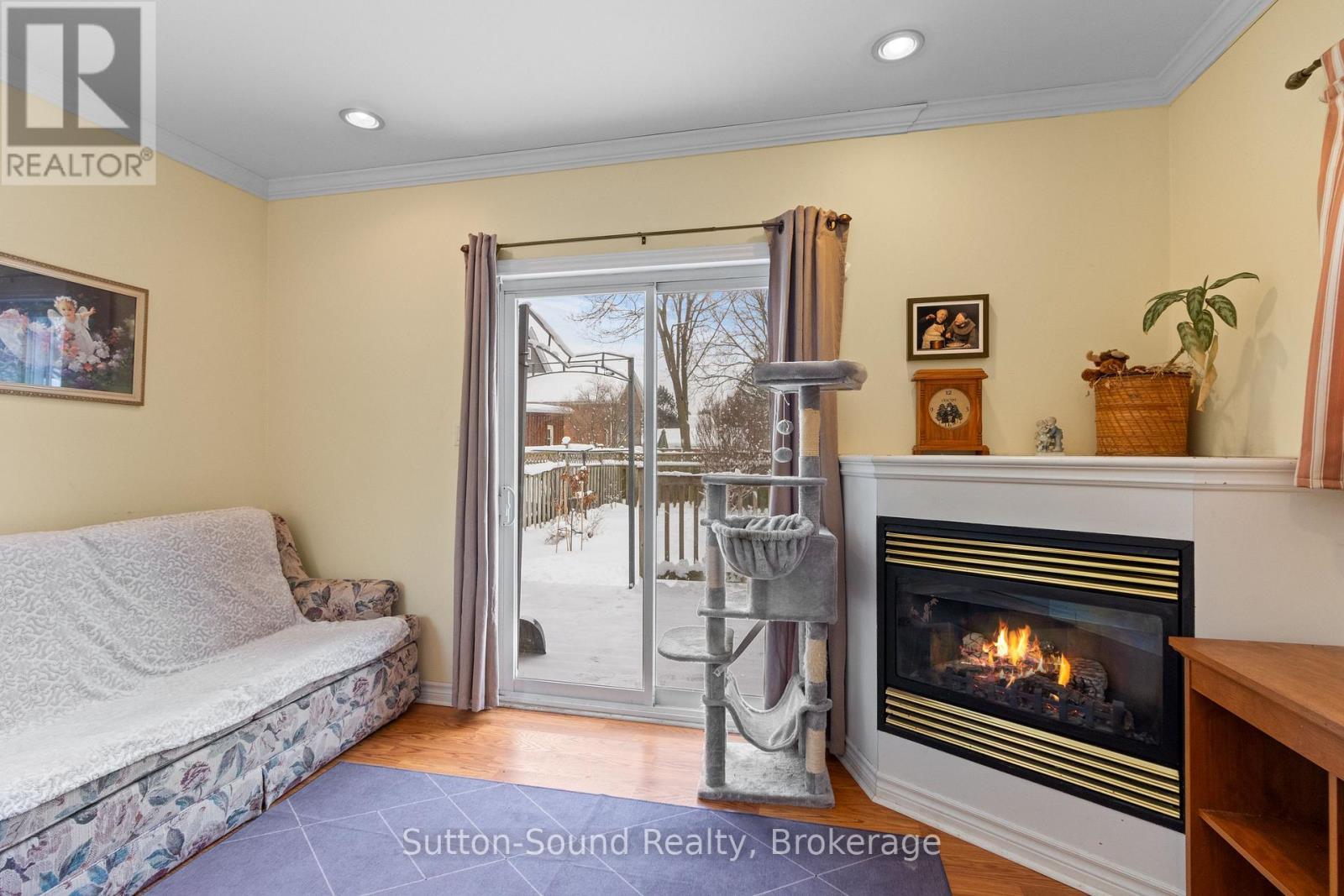 Walk out to fenced backyard - 269 6Th Street E, Owen Sound, ON - Indoor Photo Showing Living Room With Fireplace