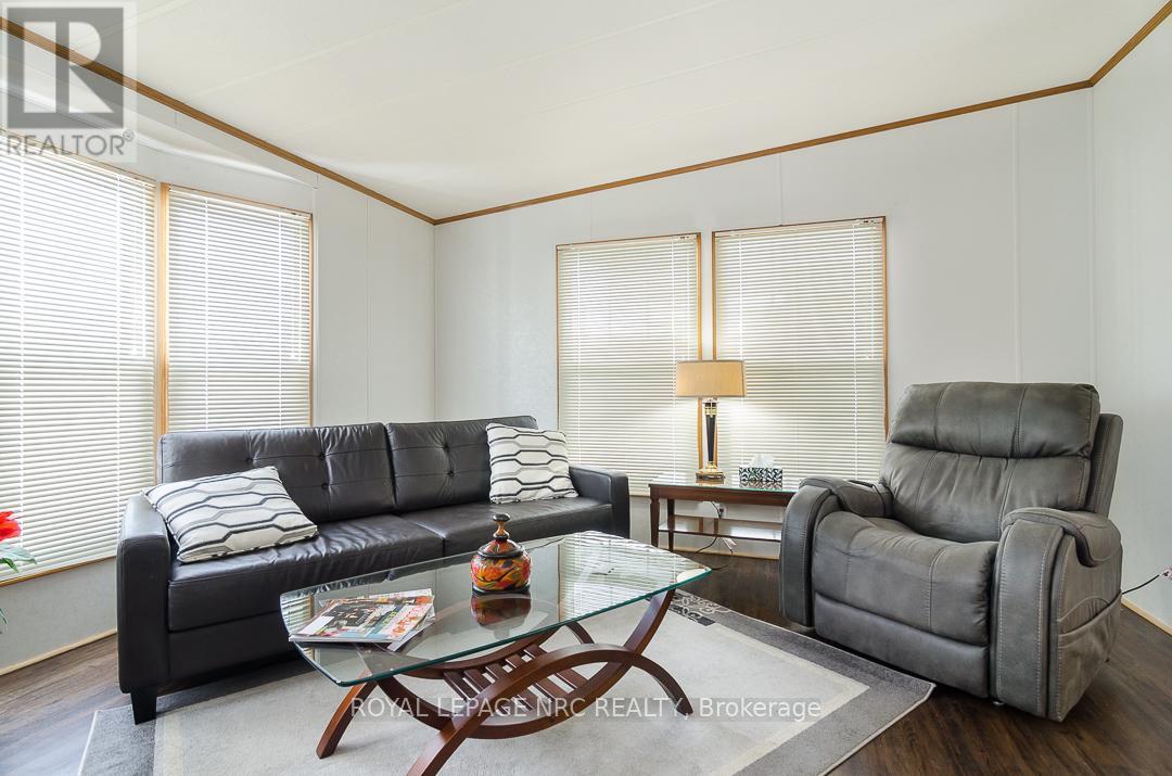 Living Rm w/ Fireplace - 254 - 3033 Townline Road, Fort Erie (Black Creek), ON - Indoor Photo Showing Living Room