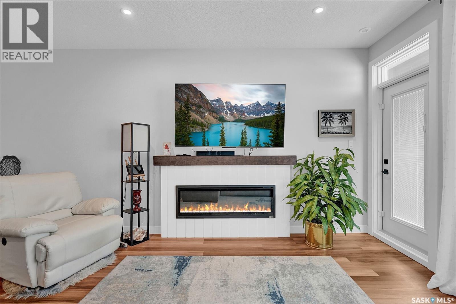 206 3581 Evans Court, Regina, SK - Indoor Photo Showing Living Room With Fireplace