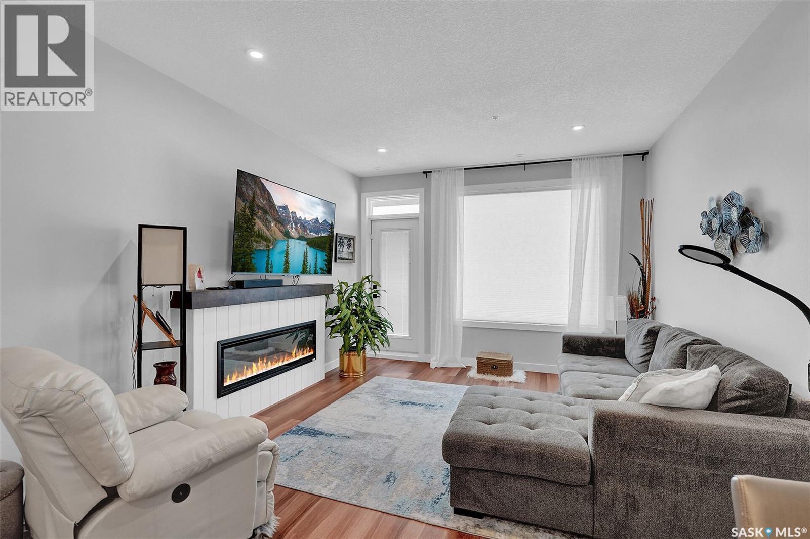206 3581 Evans Court, Regina, SK - Indoor Photo Showing Living Room With Fireplace