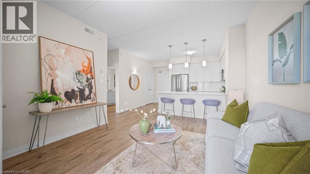 Living room featuring light wood finished floors and baseboards - 610 Farmstead Drive Unit# 304, Milton, ON - Indoor