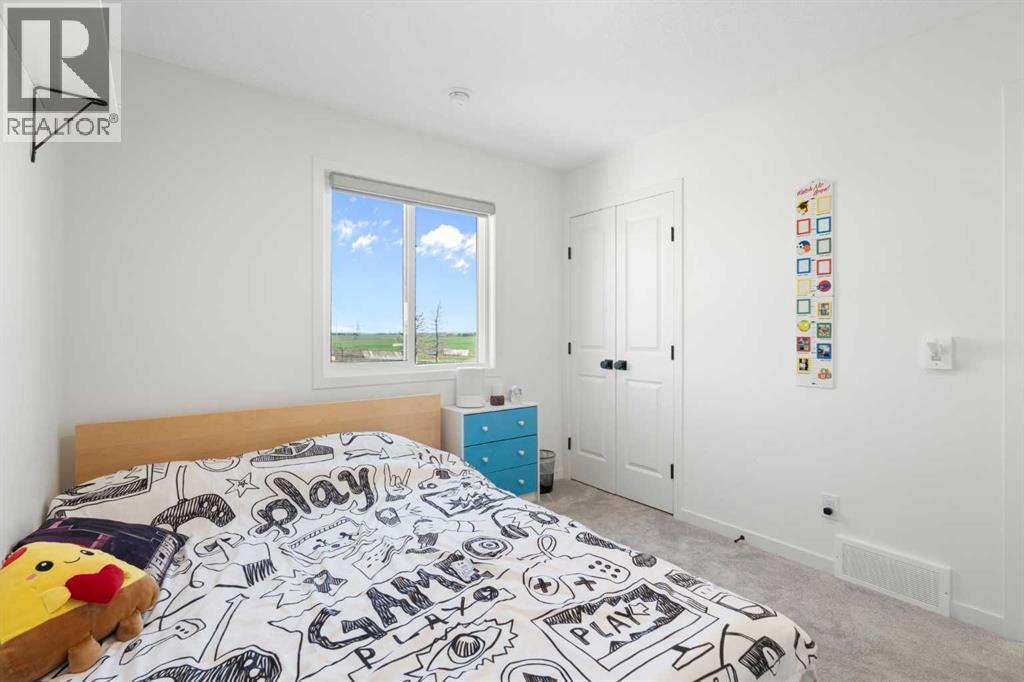 36 Magnolia Bay Se, Calgary, AB - Indoor Photo Showing Bedroom
