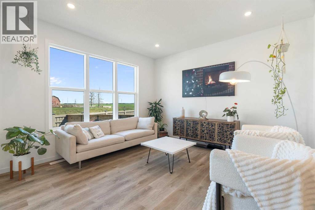 36 Magnolia Bay Se, Calgary, AB - Indoor Photo Showing Living Room