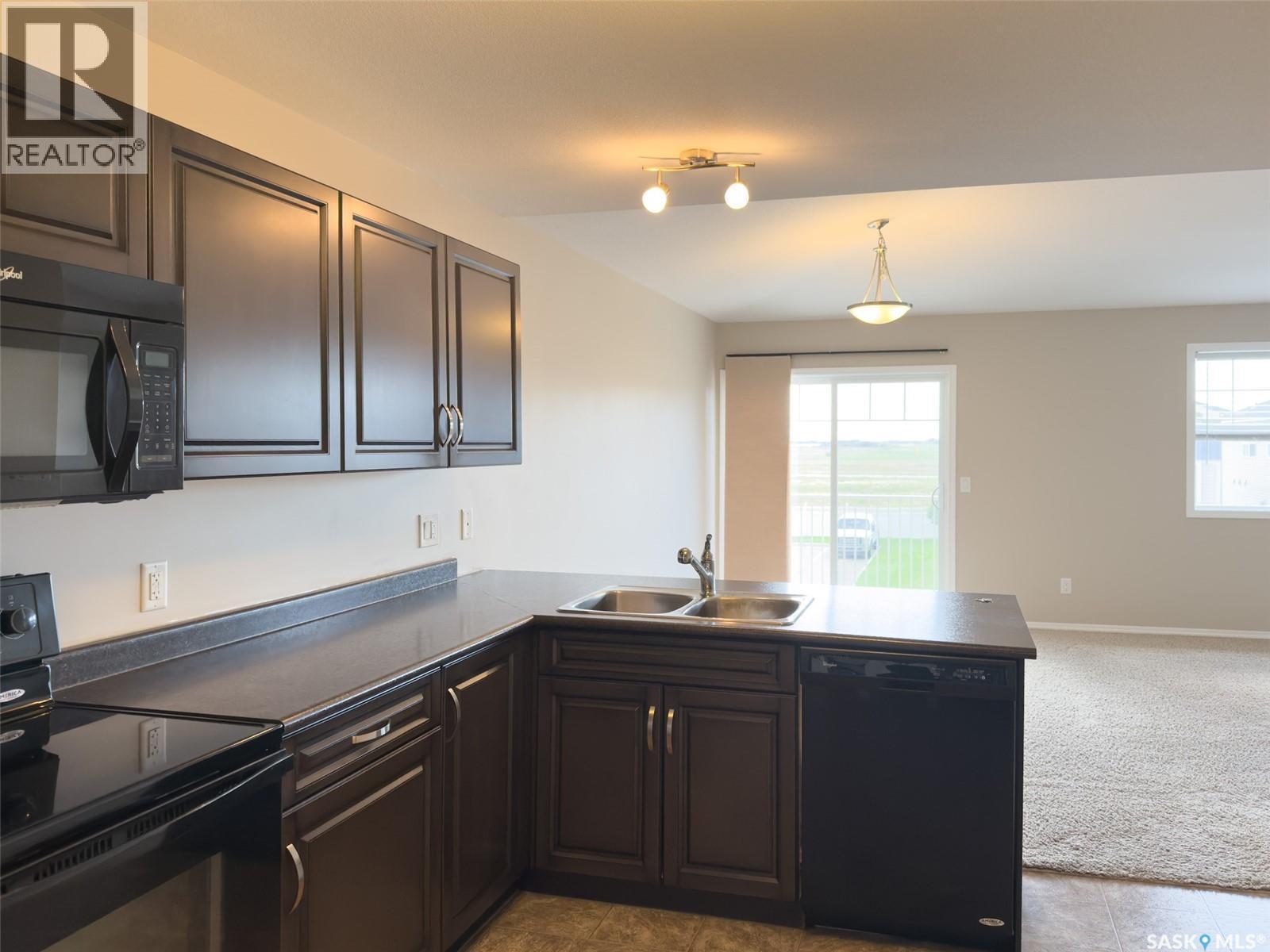 329 100 Chaparral Boulevard, Martensville, SK - Indoor Photo Showing Kitchen With Double Sink