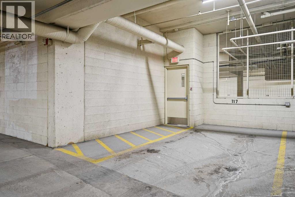 Spacious underground titled parking stall #117 - 306, 660 Eau Claire Avenue Sw, Calgary, AB - Indoor Photo Showing Garage