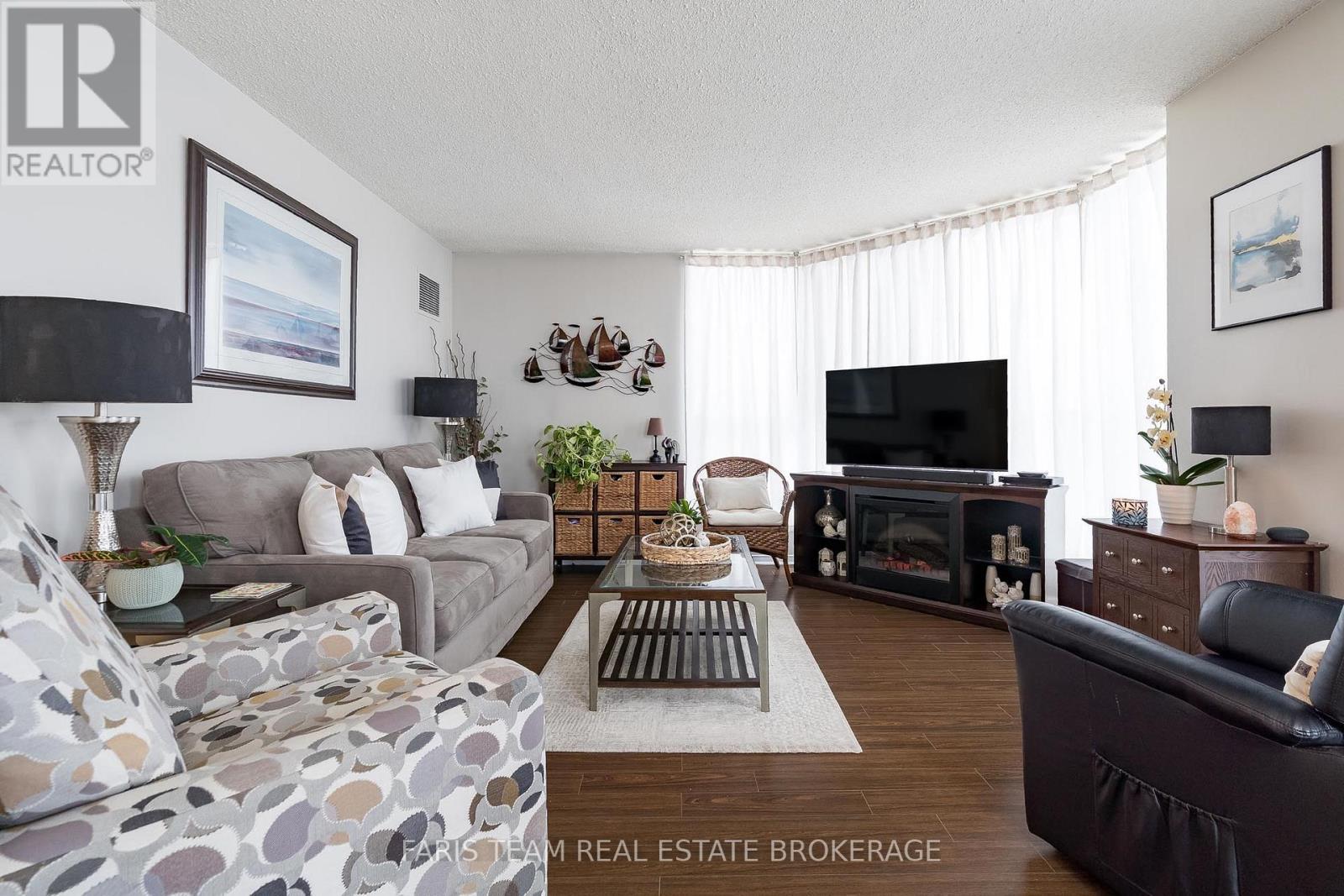 511 - 150 Dunlop Street E, Barrie, ON - Indoor Photo Showing Living Room With Fireplace