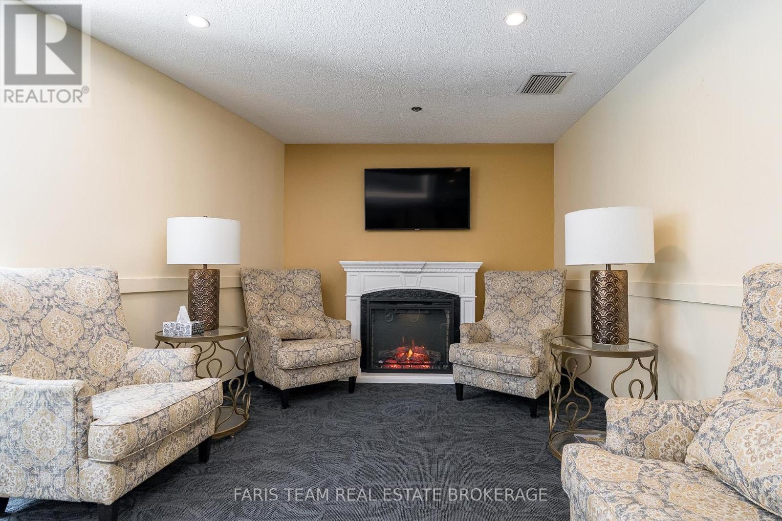 511 - 150 Dunlop Street E, Barrie, ON - Indoor Photo Showing Living Room With Fireplace