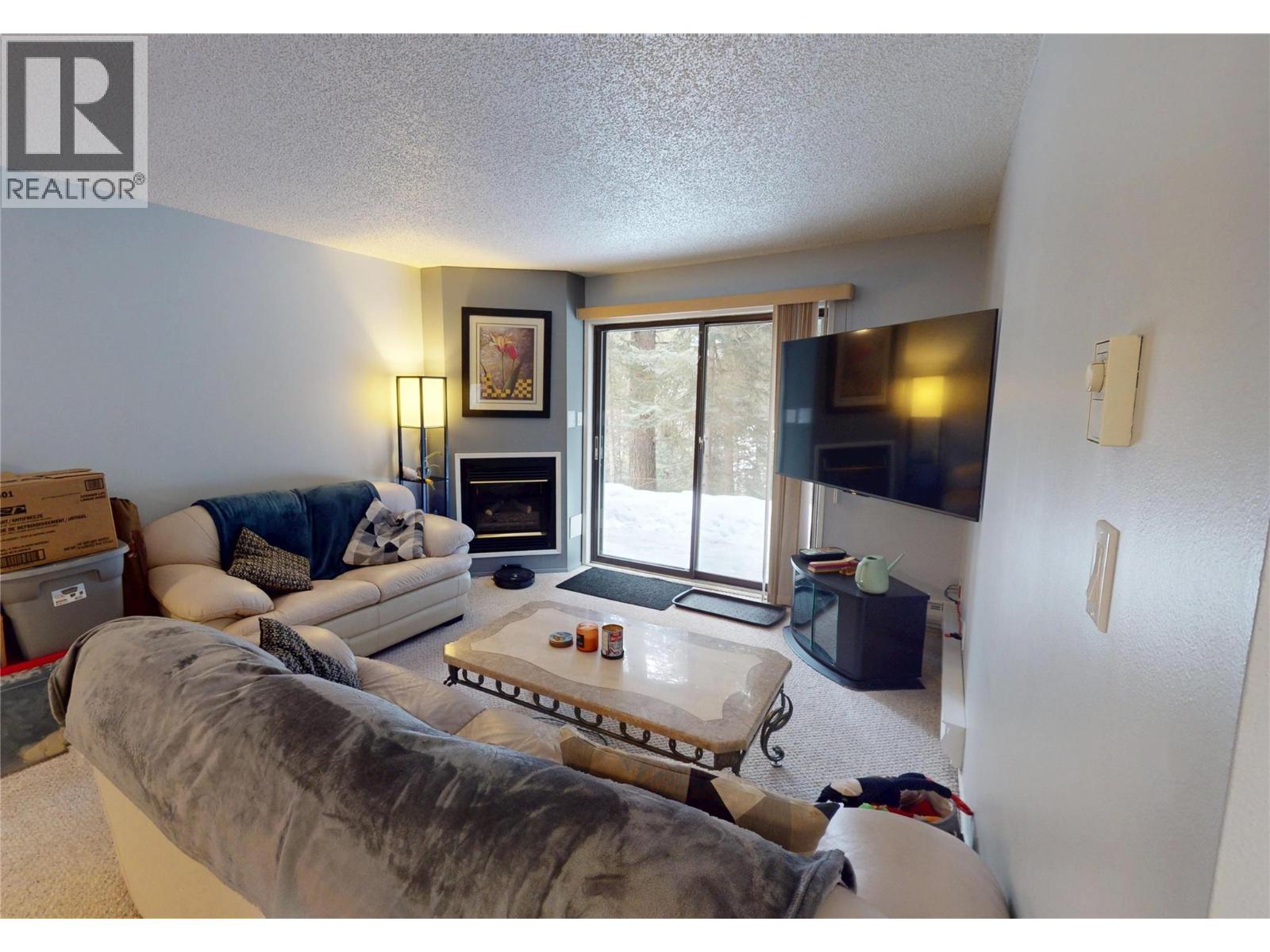 105A 1802 Alpine Drive, Elkford, BC - Indoor Photo Showing Living Room With Fireplace