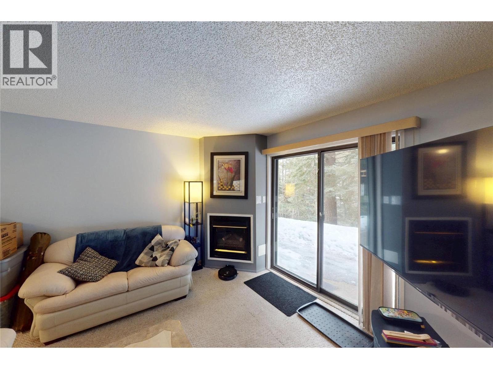 105A 1802 Alpine Drive, Elkford, BC - Indoor Photo Showing Living Room With Fireplace