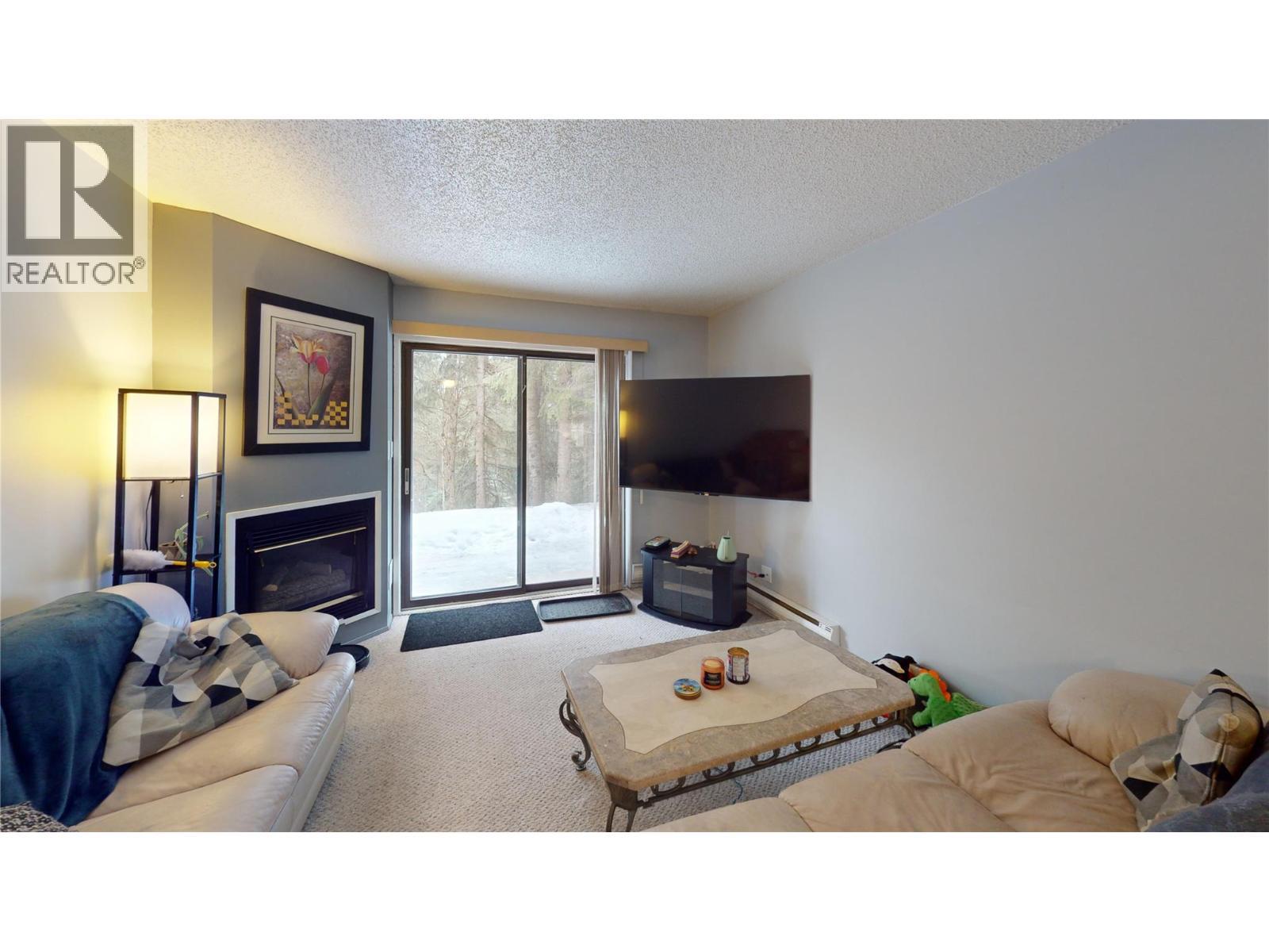 105A 1802 Alpine Drive, Elkford, BC - Indoor Photo Showing Living Room With Fireplace