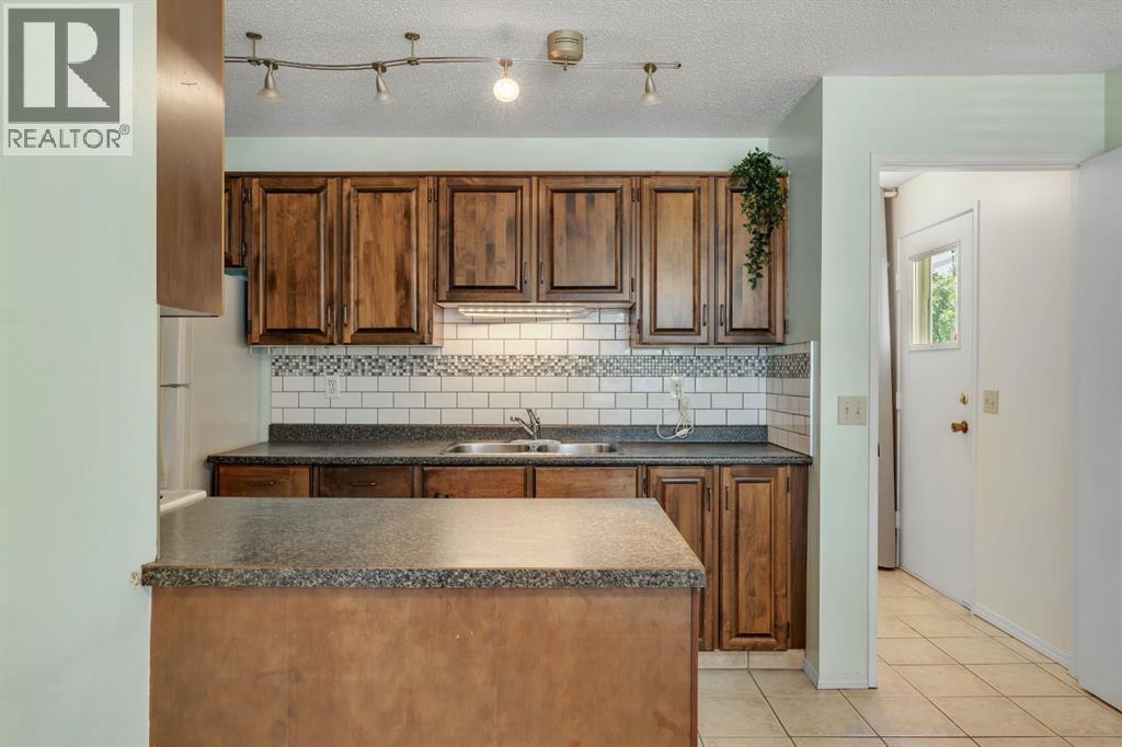 127 Falshire Way Ne, Calgary, AB - Indoor Photo Showing Kitchen With Double Sink