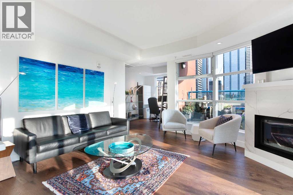 1005, 205 Riverfront Avenue Sw, Calgary, AB - Indoor Photo Showing Living Room With Fireplace