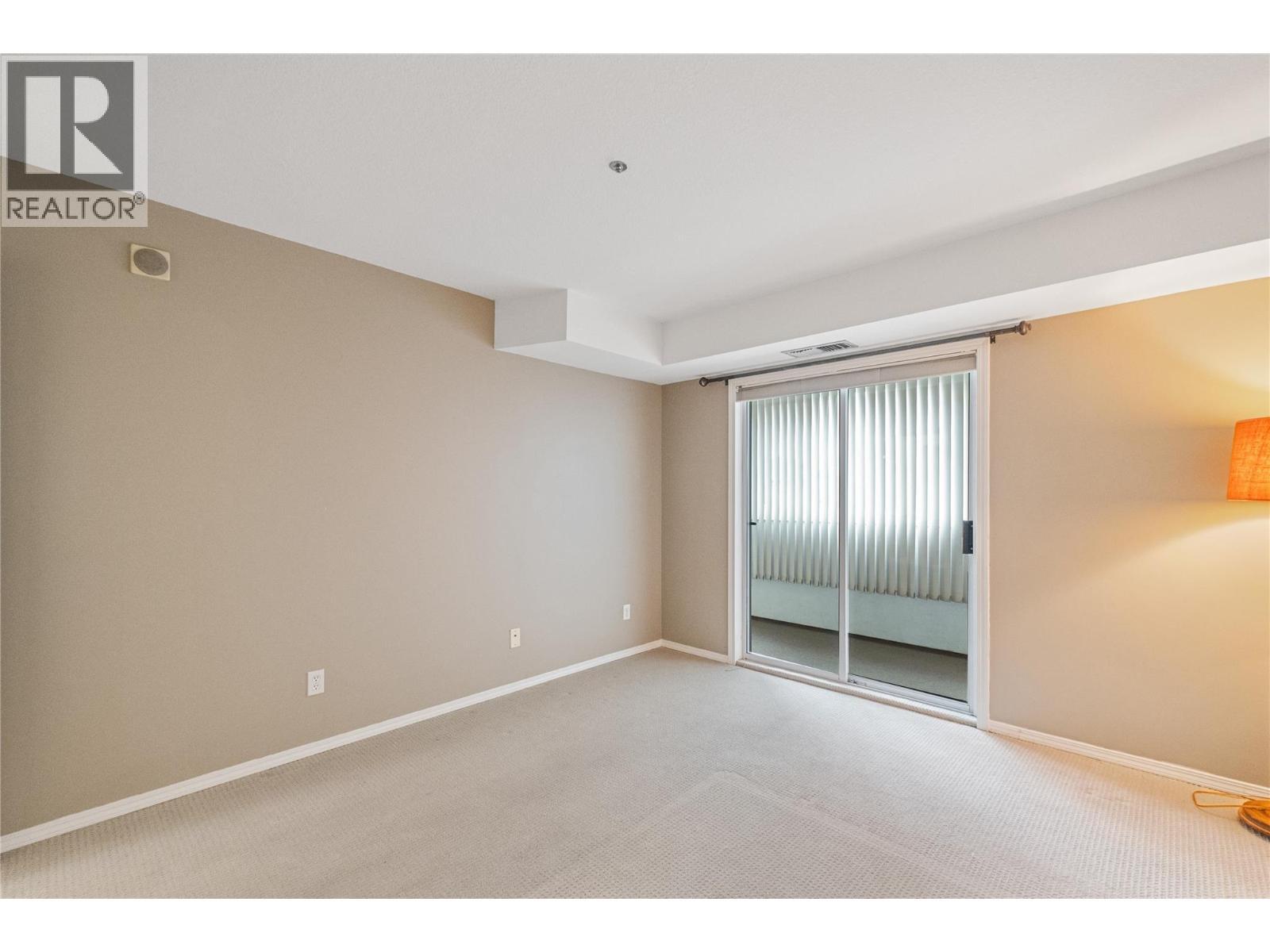 Primary Bedroom - access to patio - 1045 Sutherland Avenue Unit# 323, Kelowna, BC - Indoor Photo Showing Other Room