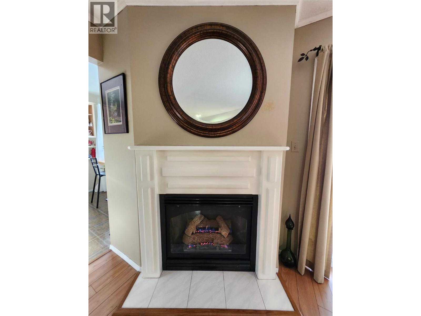 Cozy fireplace adds great ambiance - 4404 Pleasant Valley Road Unit# 6, Vernon, BC - Indoor Photo Showing Living Room With Fireplace