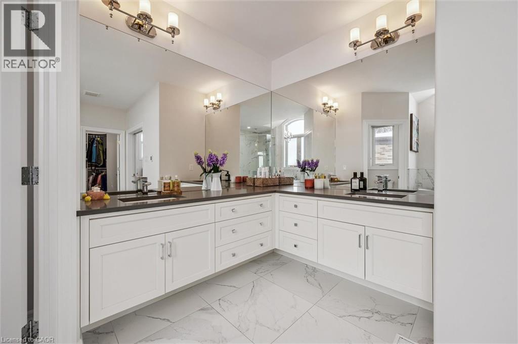 Bathroom featuring double vanity, light marble finish flooring, and a walk in closet - 263 Chestnut Ridge, Waterloo, ON - Indoor Photo Showing Bathroom