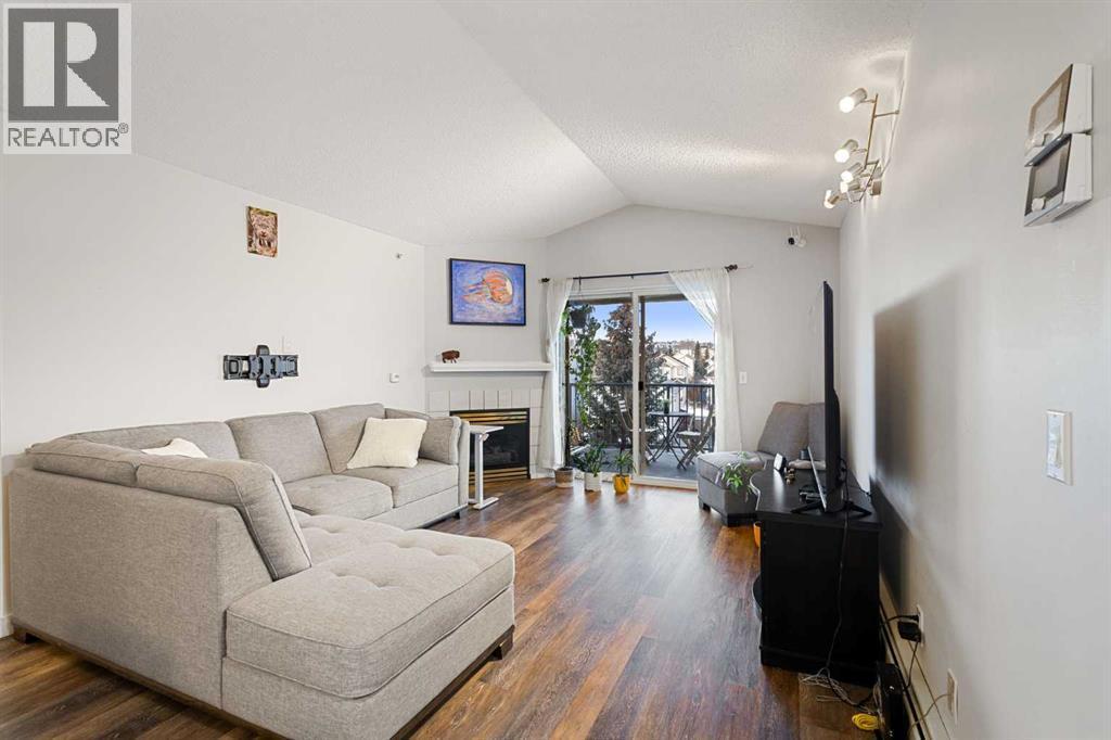 510, 55 Arbour Grove Close Nw, Calgary, AB - Indoor Photo Showing Living Room With Fireplace