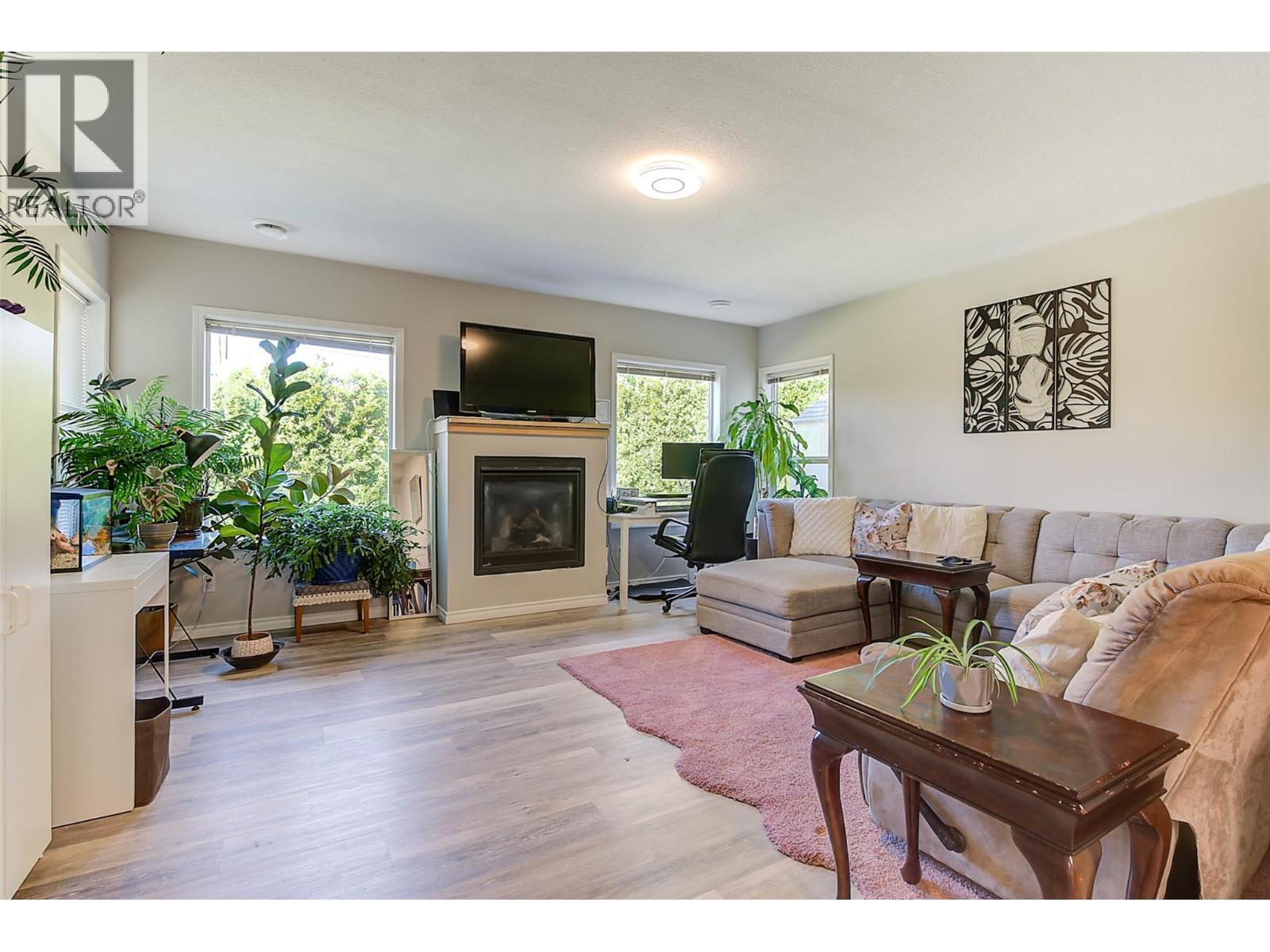 Living room in suite - 1420 Bentien Road, Kelowna, BC - Indoor Photo Showing Living Room With Fireplace