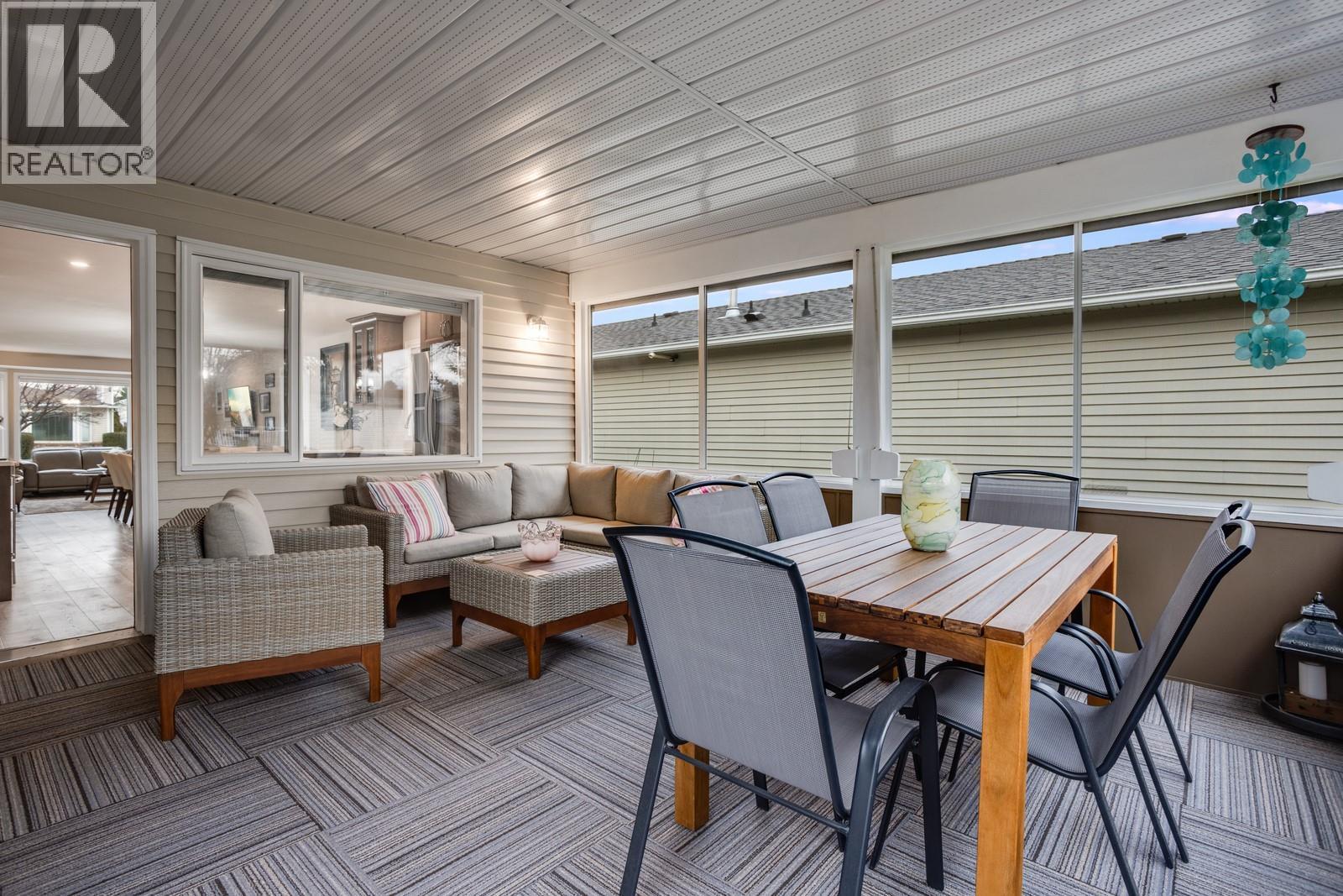 Bright sunroom offering additional year-round living space and relaxation. - 1255 Raymer Avenue Unit# 507, Kelowna, BC - Outdoor With Deck Patio Veranda With Exterior