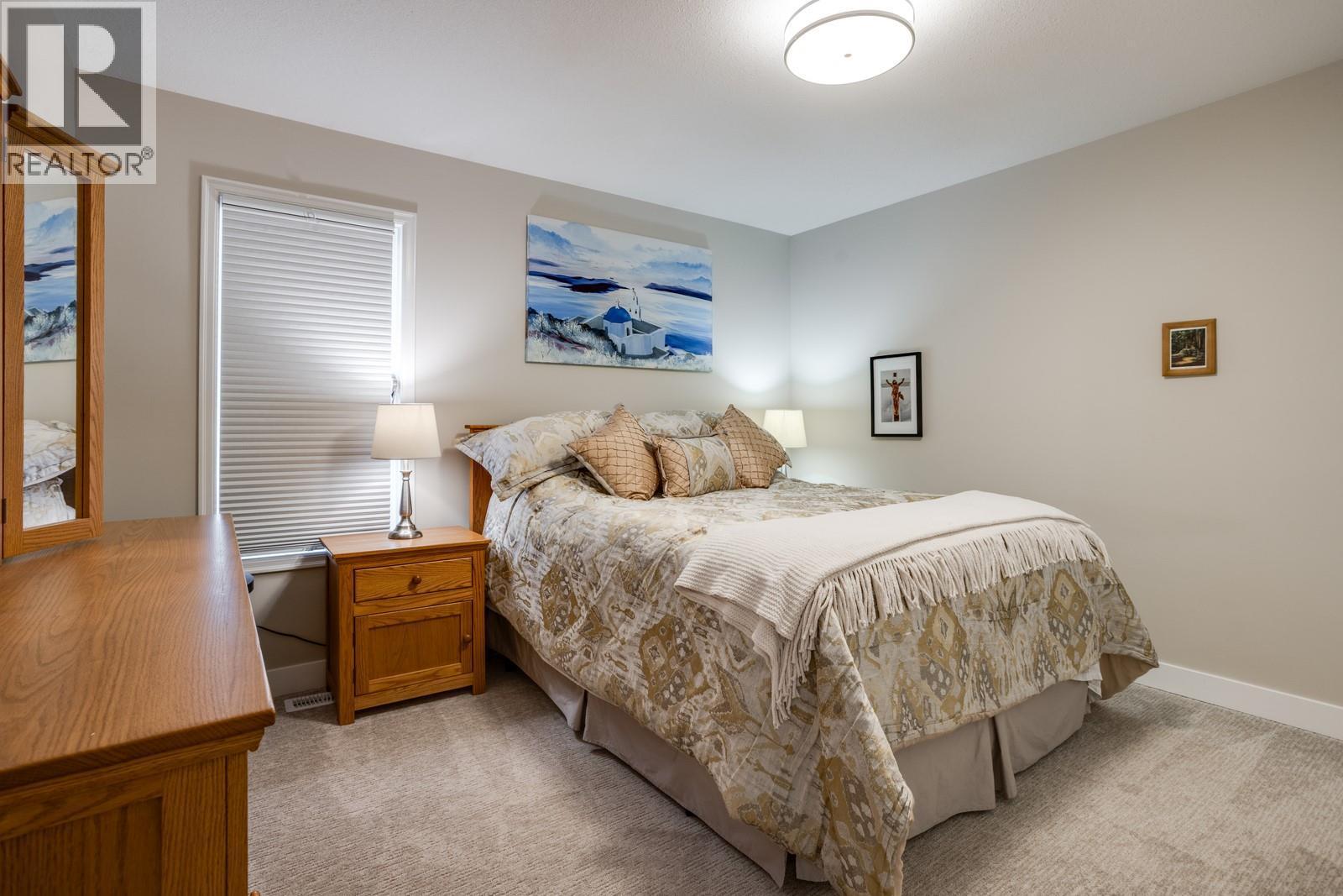 Generous second bedroom ideal for guests, office, or hobbies. - 1255 Raymer Avenue Unit# 507, Kelowna, BC - Indoor Photo Showing Bedroom